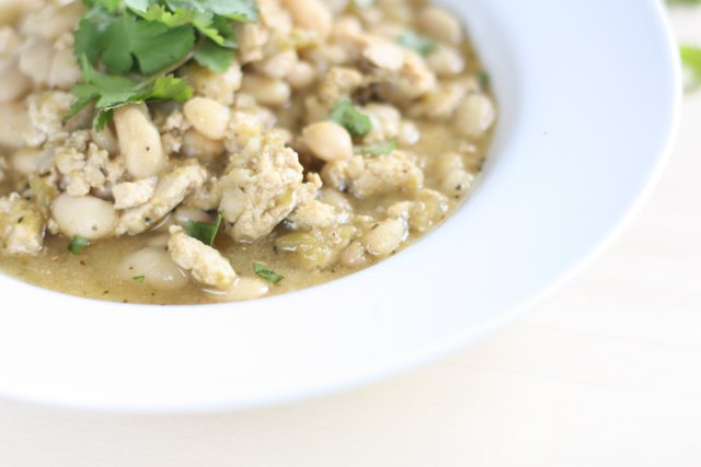 A steaming bowl of Green Turkey Chili with White Beans .