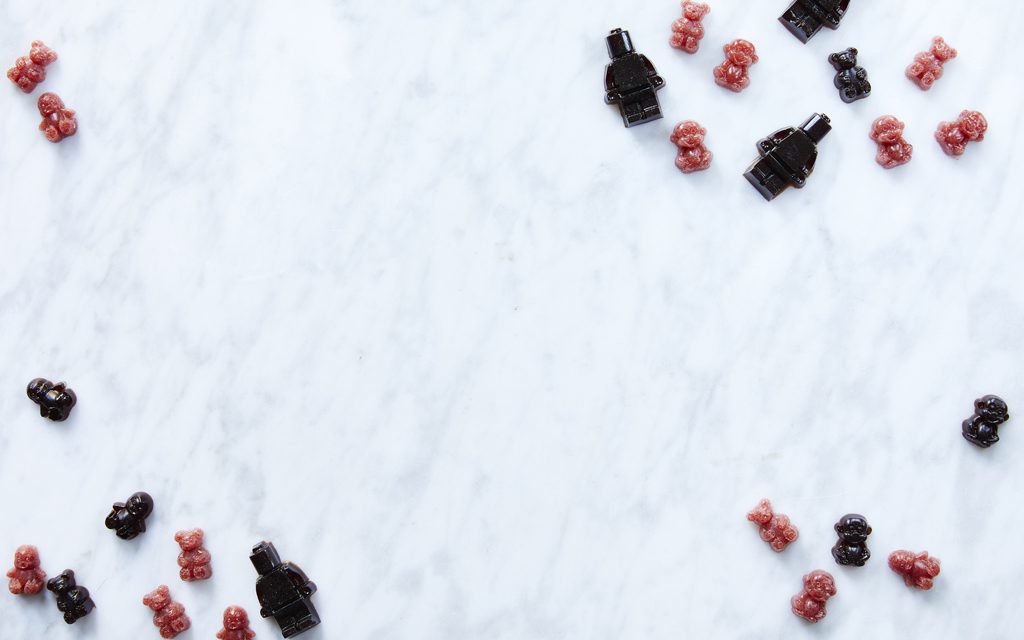 purple LEGO shaped gluten free gummies on a marble table