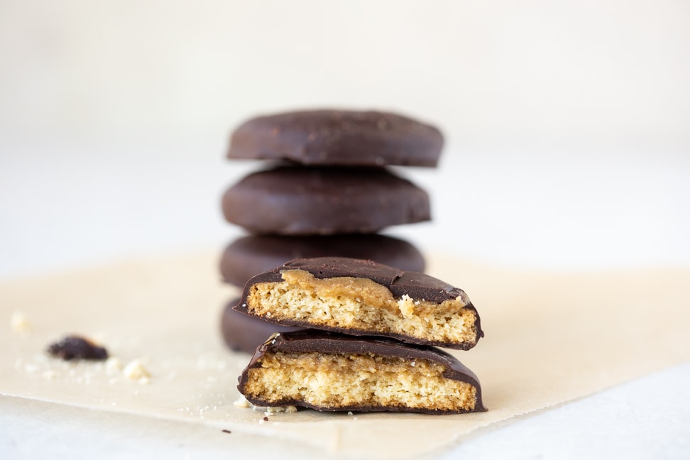 gluten free tagalong cookie on a piece of parchment paper cut in half to show the inside