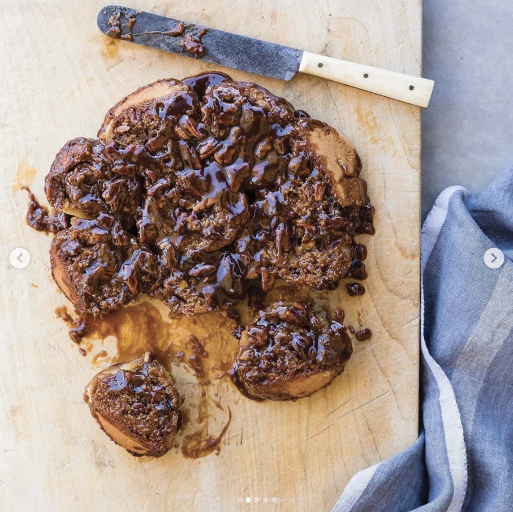 Sticky buns displayed on a wooden cutting board