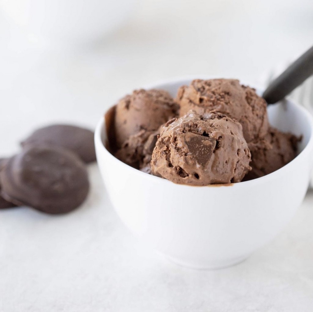 white bowl filled with generous amount of double chocolate thin mint ice cream on a white counter