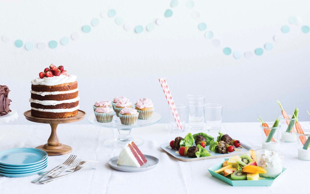 Birthday table spread with a variety of finger foods and treats