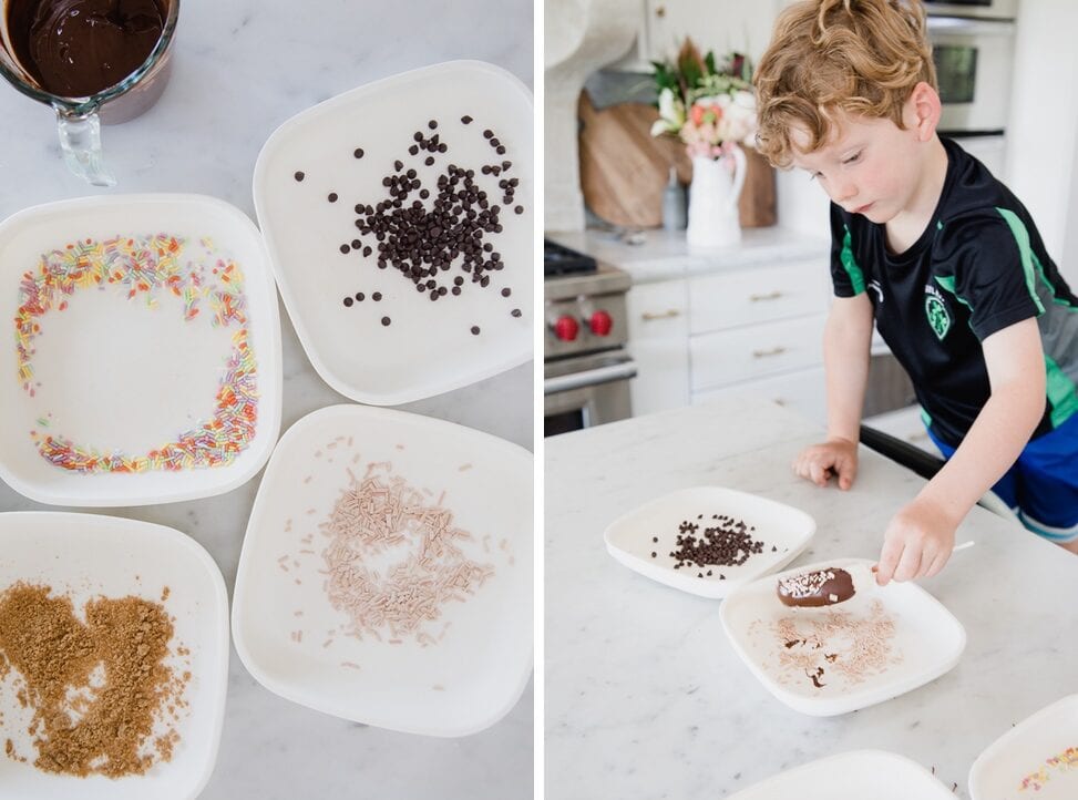 Young boy carefully adds his freshly chocolate dipped banana into one of the toppings available 